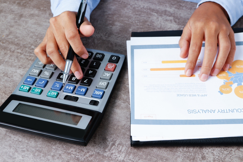 Accountant calculating financial reports and reviewing business performance data.