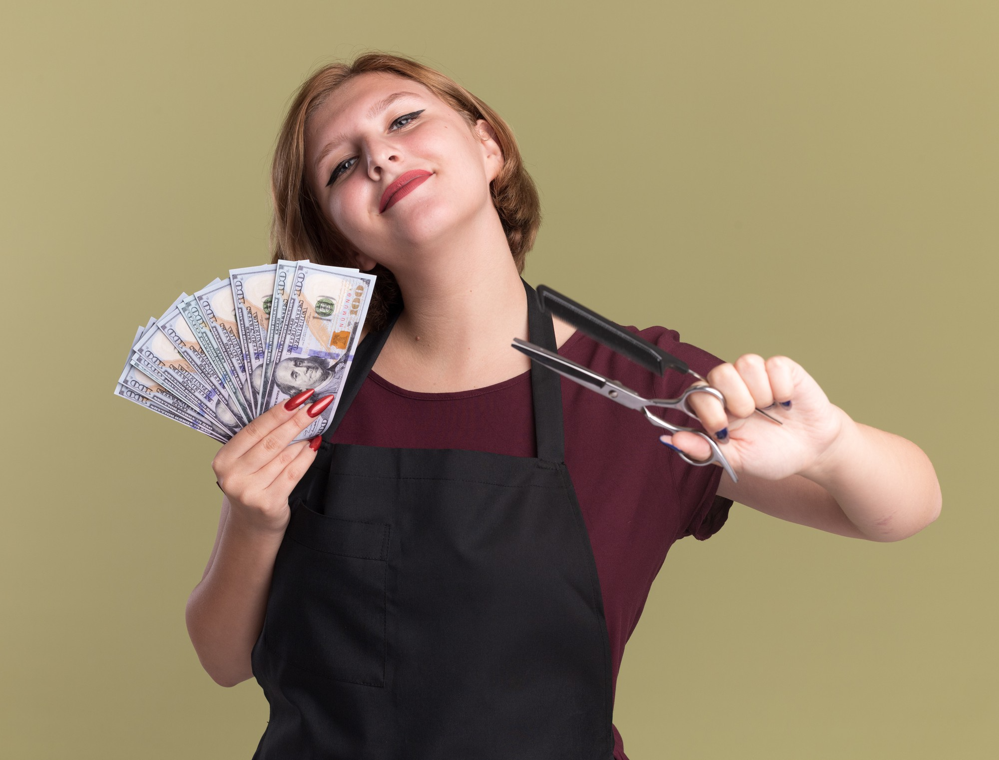 Salon owner holding cash and hair-cutting scissors, representing salon profits and business income.