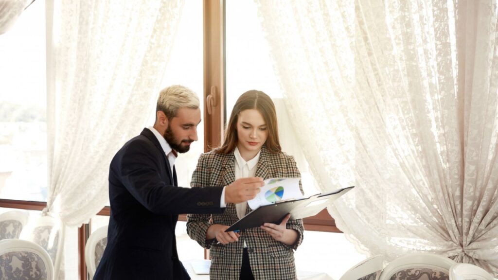 Business professionals reviewing reports and discussing strategy during a client consultation