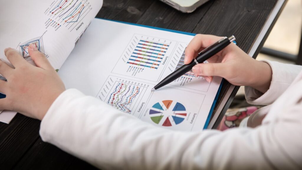 Close-up of a business report with charts and graphs being analyzed.