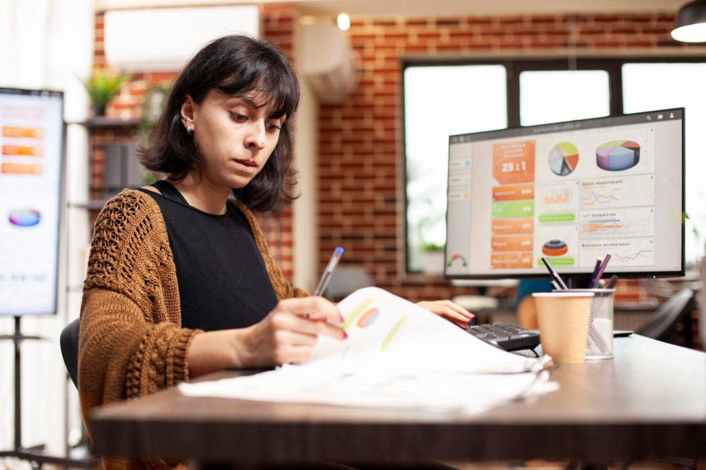 Salon owner reviewing business reports and financial performance.