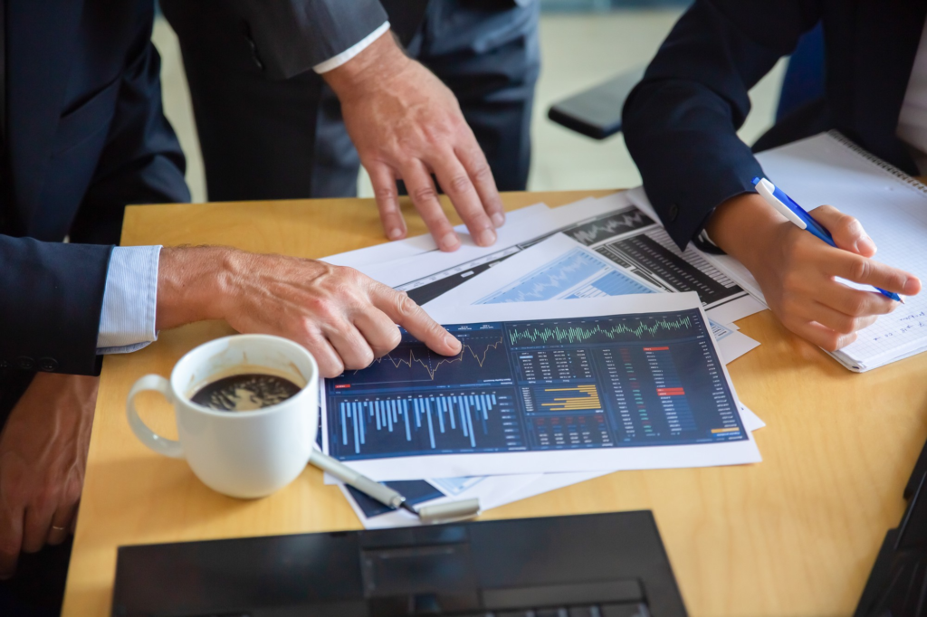 Salon professionals analyzing financial reports to improve business growth.
