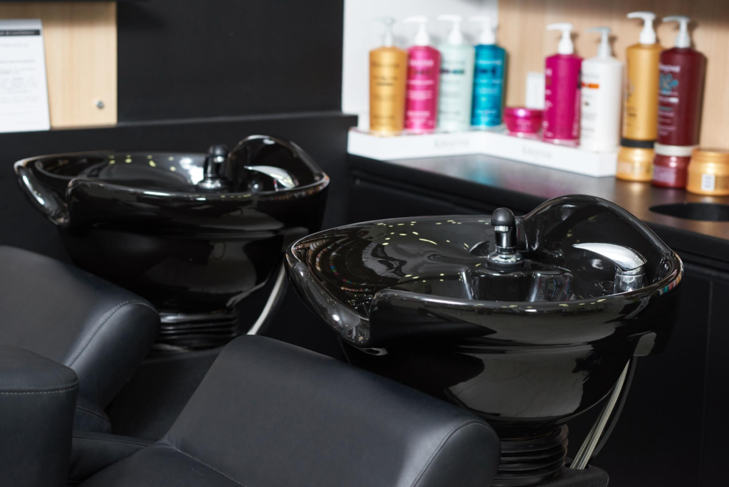 Professional salon shampoo stations with premium hair care products.